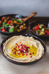 Healthy vegetarian food with hummus and salads