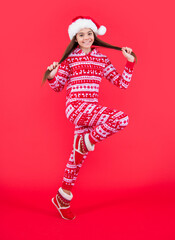 merry christmas. happy teen girl in red christmas santa hat running in studio. santa christmas girl