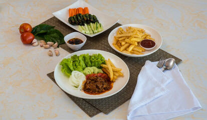 Vietnamese-Western Fusion Meal with Beef Stew, French Fries, and Fresh Vegetables