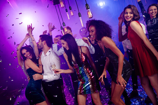 Energetic party night with friends dancing together in a neon club celebrating music and style