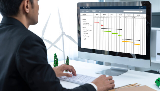 Project planning software for brisk business project management on the computer screen showing timeline chart of the team project