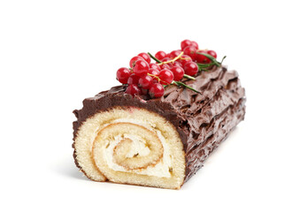 Delicious Yule log (traditional Christmas cake) with redcurrant isolated on white