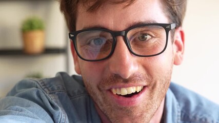 Closeup of smiling young man touching camera lens like a digital button, showing curiosity and joy, concept of technology, online interaction, and futuristic virtual connection.
 - Powered by Adobe