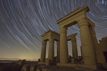 A star trail time-lapse over the ruins of an ancient civilization  