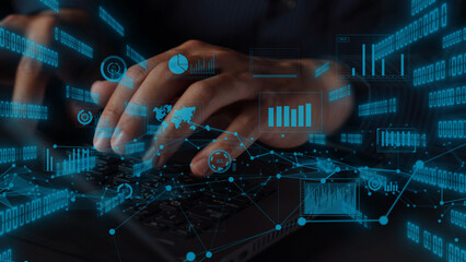 A modern workspace featuring hands typing on a laptop keyboard, surrounded by floating digital graphs and numbers, highlighting the dynamic world of data and technology. Xenic