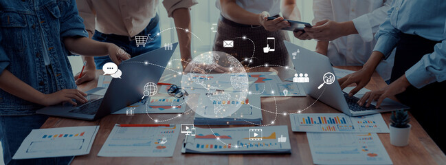 A diverse team actively engages in collaboration on data analysis, utilizing technology, charts, and graphs to enhance communication and drive project success. Trope