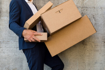 Businessman dropping some cardboard boxes he was carrying