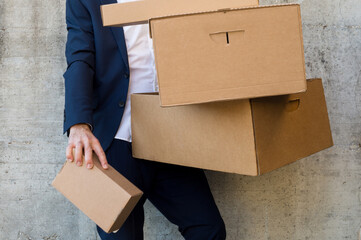 Businessman carrying a stack of unlabeled boxes