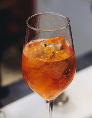 Barman mixing liquor beverages and alcohol drinks in plastic cups, bartender working, beautiful row line of different coloured cocktails on open air summer party in a bar, catering on banquet event