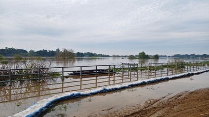 A large river overflowing its banks indicates a flood situation.