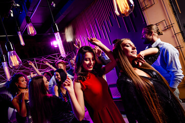 Energetic party scene of friends dancing at a nightclub with neon lights smiling crowd and festive vibe at a big event