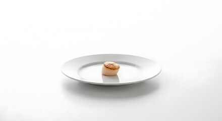 A Single Small Macaron on a White Plate.
