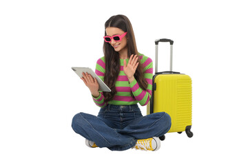 Woman smiles and waves with a tablet and suitcase, isolated, PNG