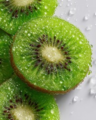 Fresh Kiwi Slices with Water Droplets on Light Background