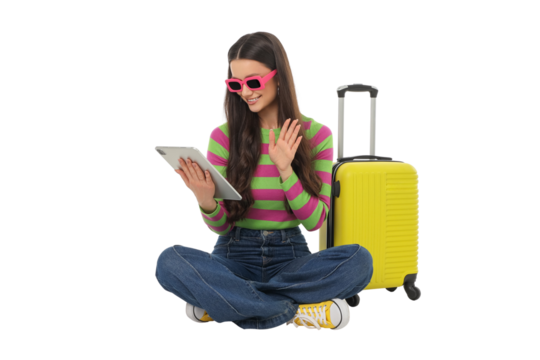 Woman smiles and waves with a tablet and suitcase, isolated, PNG - Powered by Adobe