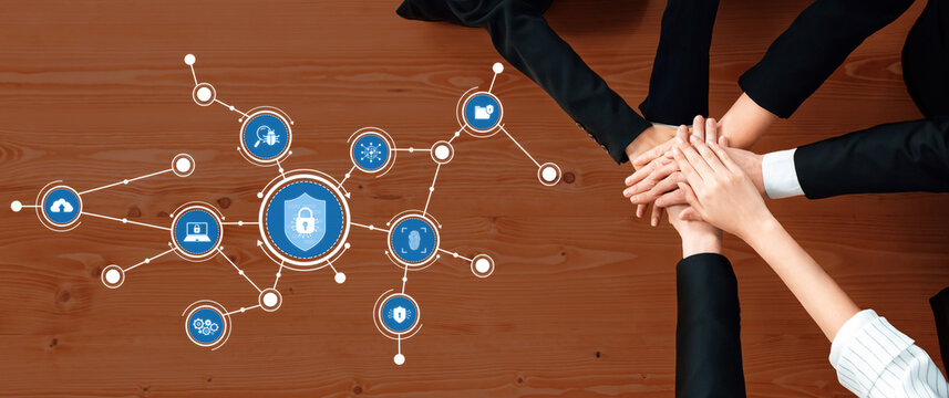 A diverse group of professionals collaborates in a modern office setting, symbolizing teamwork around security solutions, highlighted with digital connection icons. Amity