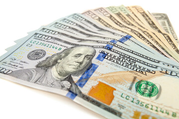 US dollar banknotes fanned out on white background