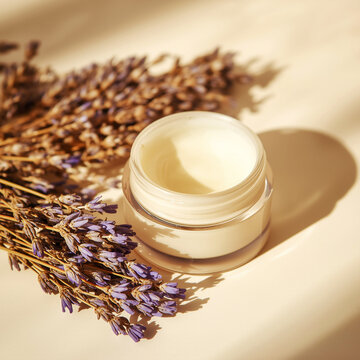 Natural lavender skincare cream jar on beige background with warm sunlight