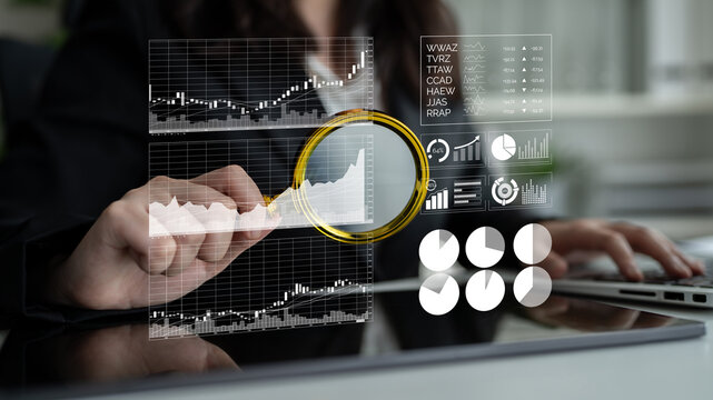 A business professional conducts an in-depth analysis of stock market trends using modern graphs and charts to gain clearer insights into financial data. Impute - Powered by Adobe