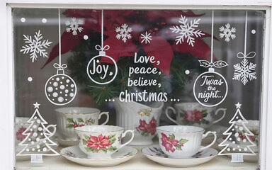 Christmas window with decals, snowflakes, and festive teacups