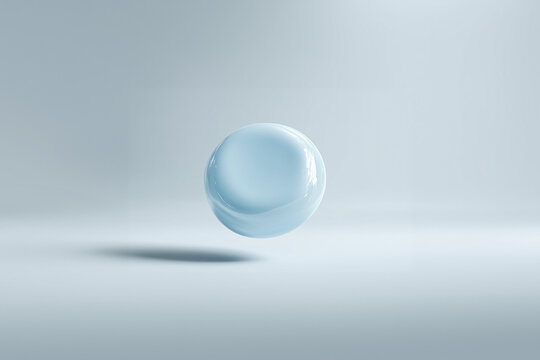 Transparent baby blue glass sphere floating on a light background