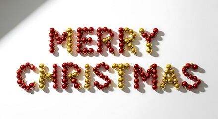 Merry christmas message spelled out with red and gold christmas balls on a white background creating a festive holiday season greeting and joyful celebration