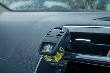 Close up of an air freshener installed in the car AC vent