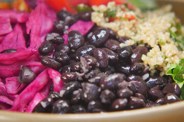 Colorful bean and quinoa salad with fresh toppings