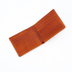 Open and empty matte tan leather bifold wallet isolated on white background