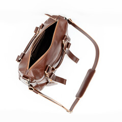 Empty and open brown leather bag on white background