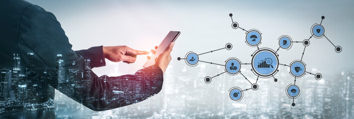 A businessman engages with a smartphone for data analysis in a futuristic city setting, symbolizing the integration of technology and modern business practices. Tessel