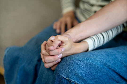 Adult couple hands holding together showing care compassion and emotional support during difficult times symbolizing love and trust relationship