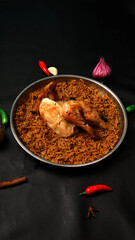 Cooked Chicken and Spiced Rice in Metal Bowl with Garlic Chili Pepper and Star Anise on Black Surface