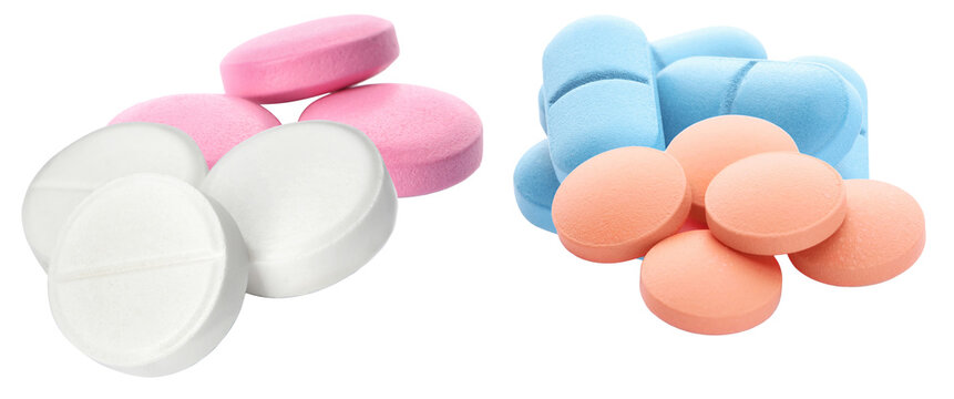 photograph showcasing a large variety of colorful pills and tablets, including white, pink, blue, and orange, mixed together against black.