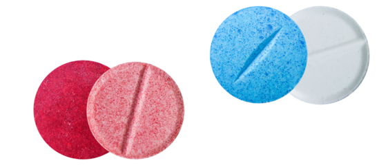 photograph of textured, brightly colored round effervescent tablets in red, pink, blue, and white, isolated on a transparent background.