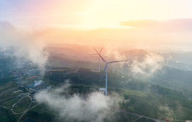 Fototapeta premium Majestic wind generator amidst misty landscape in Da lat Vietnam at sunrise