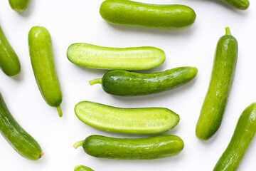 Fresh mini baby cucumbers on white background