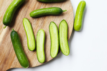 Fresh mini baby cucumbers on white background