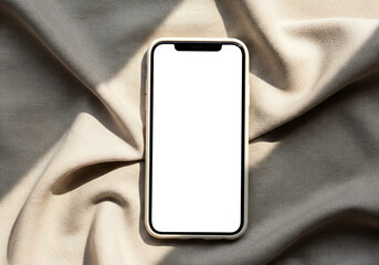 Smartphone Mockup With Blank Screen on Textured Neutral Fabric Background in Warm Light For UI Design or Advertisement with Shadows Mobile Phone Device Flat Lay