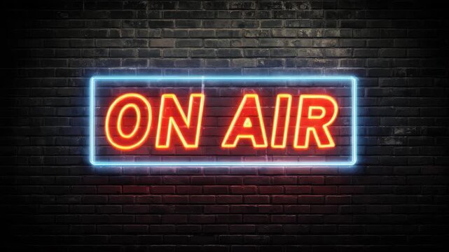 Neon sign glowing on a dark brick wall creating a vibrant atmosphere for live broadcasts and creative events