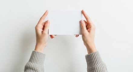 Female Hands Holding Blank White Card Mockup on White Background