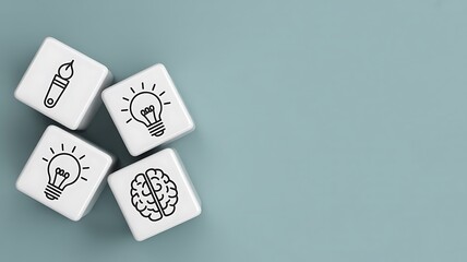 Symbolic icons on white cubes representing the creative process and innovation