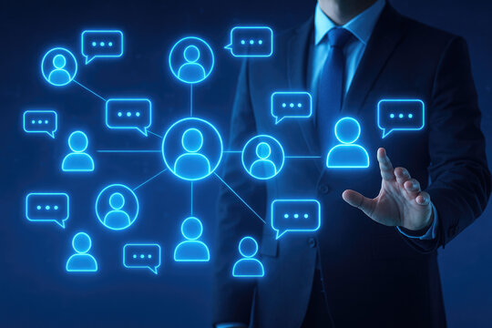 Businessman interacting with a glowing network of people and chat bubbles on a dark background hand touching