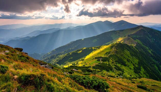 Golden hour illuminates rolling green mountains under a dramatic cloudy sky, creating a breathtaking natural landscape