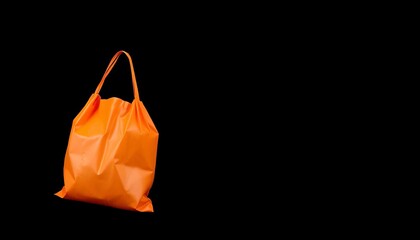Bright orange plastic grocery bag isolated on black ,  waste,  commerce