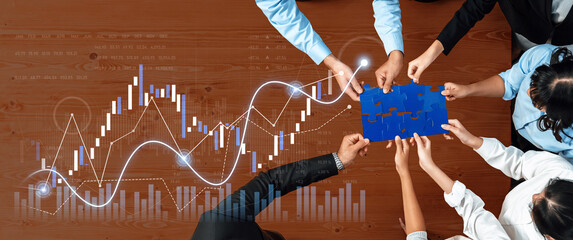 Diverse team collaborates over a puzzle piece representing strategy while analyzing growth data, showcasing teamwork and innovation in a business setting. Scalp