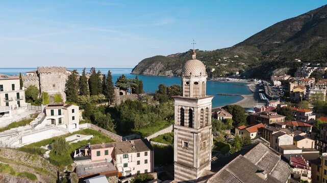 Drone view over Levanto, revealing its historic tower and colorful seaside buildings along the Ligurian coast.
