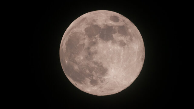 A Detailed Close-Up View of the Luminous Full Moon, Clearly Showcasing its Textured Surface, Craters, and Dark Maria Against a Black Sky. - Powered by Adobe