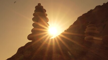 Stones cairn sunset, balanced stacked rocks silhouetted by bright sun rays over a tranquil mountain - Powered by Adobe