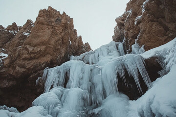 partially frozen waterfall cascading over jagged icy rocks